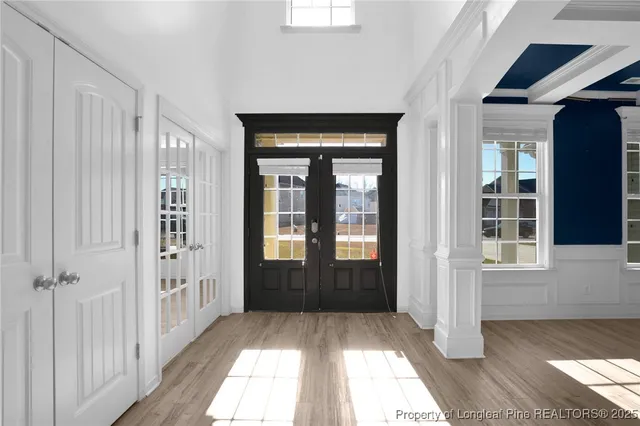 an empty room with windows and fireplace