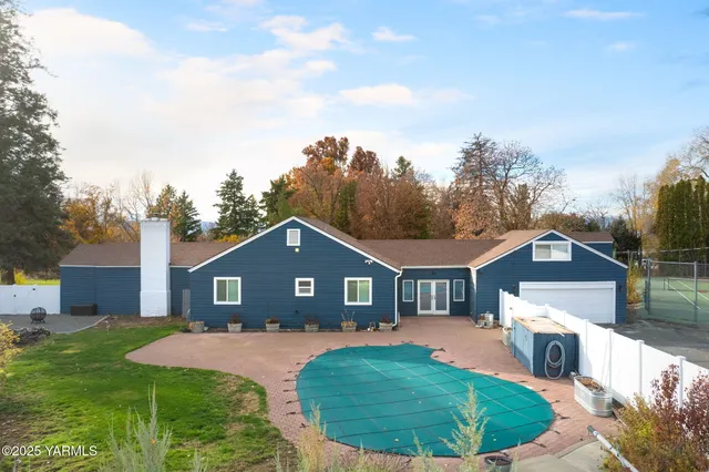 a aerial view of a house with a yard and garage