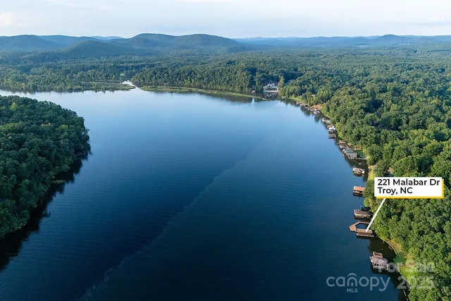 an aerial view of a house with garden space and lake view