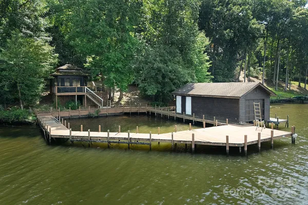 a view of a house with swimming pool and sitting area