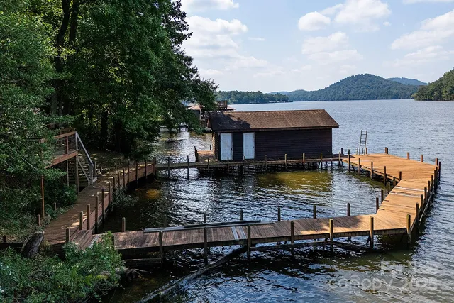 a view of a house with swimming pool and a yard