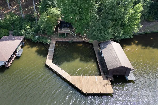 a wooden bench sitting in the middle of a lake