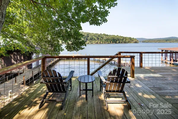 a view of a patio on wooden deck and lake view