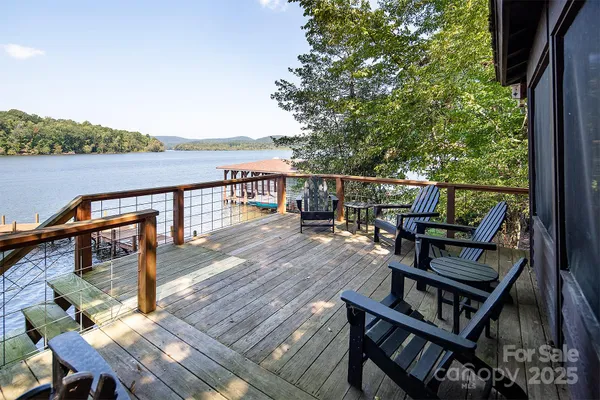 a view of a balcony with wooden chairs and wooden floor
