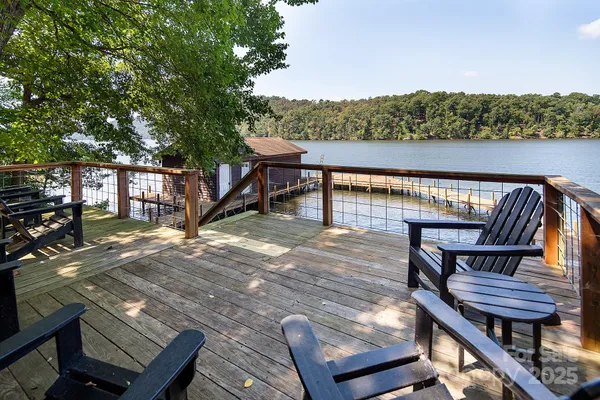 a view of a balcony with wooden floor and outdoor seating