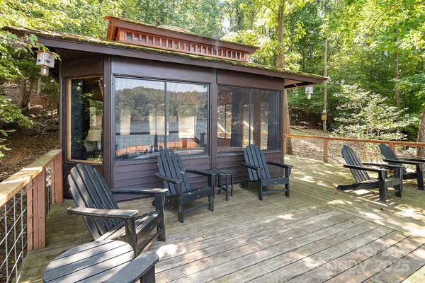 a view of a patio with table and chairs and wooden floor