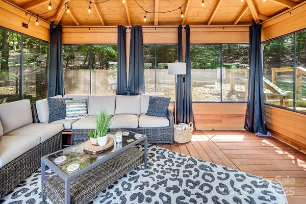 a outdoor space with the couches and dining table with the garden view