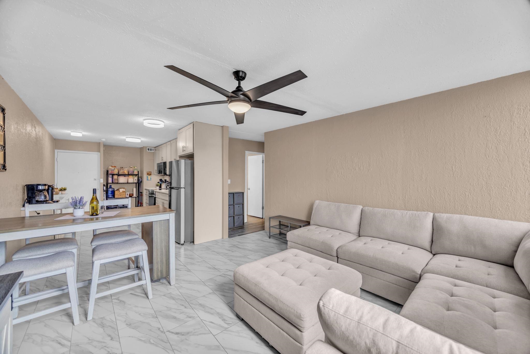 111 Kahului Beach Road, Unit D402 Kahului, HI 96732 - Photo 11 of 35 a living room with furniture kitchen view and a wooden floor