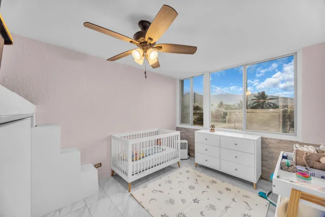a very nice looking room with a ceiling fan and a window