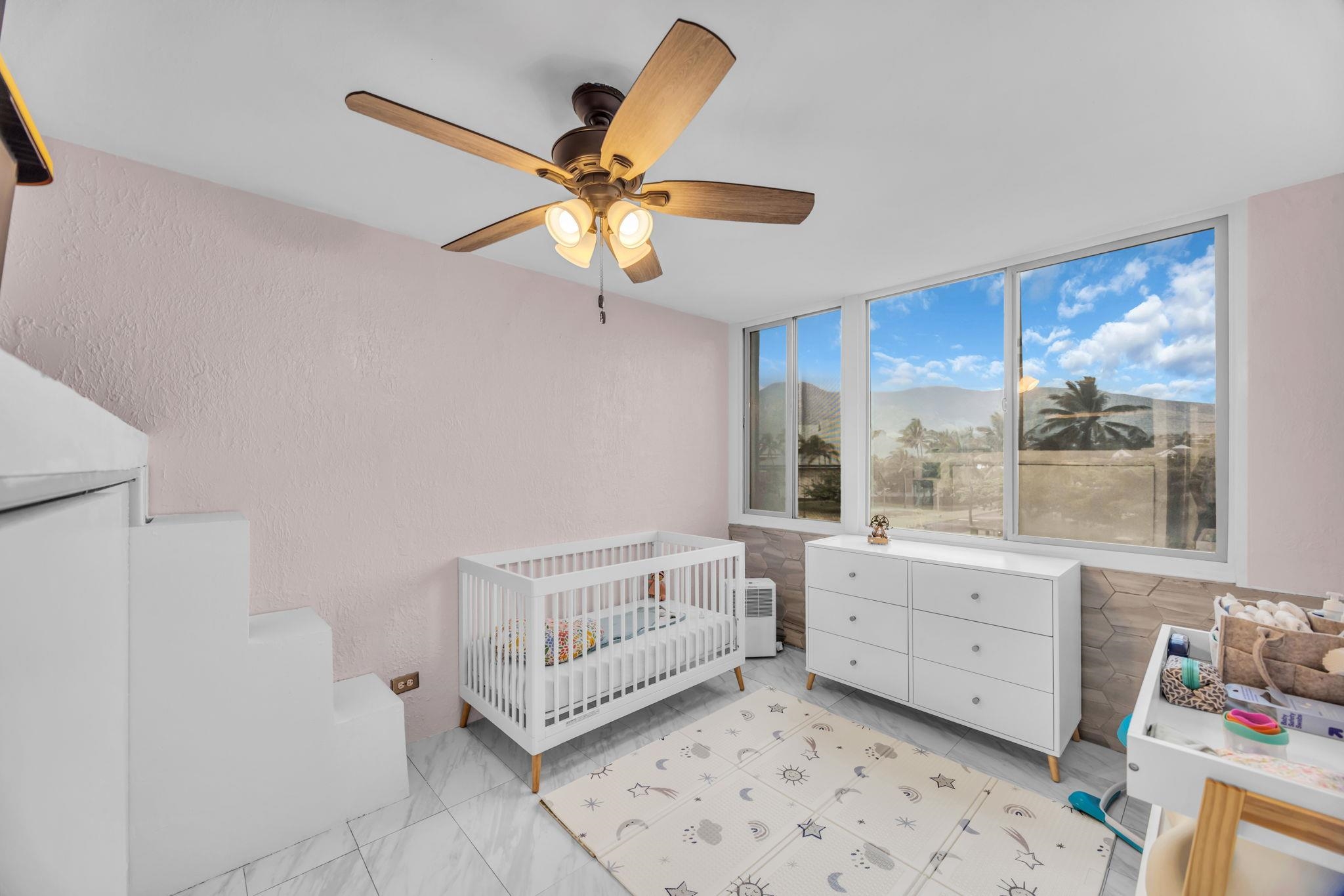 111 Kahului Beach Road, Unit D402 Kahului, HI 96732 - Photo 17 of 35 a very nice looking room with a ceiling fan and a window