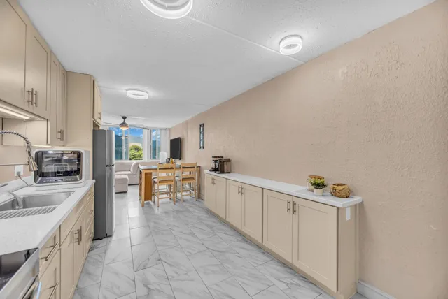 a kitchen with granite countertop a sink stove and cabinets