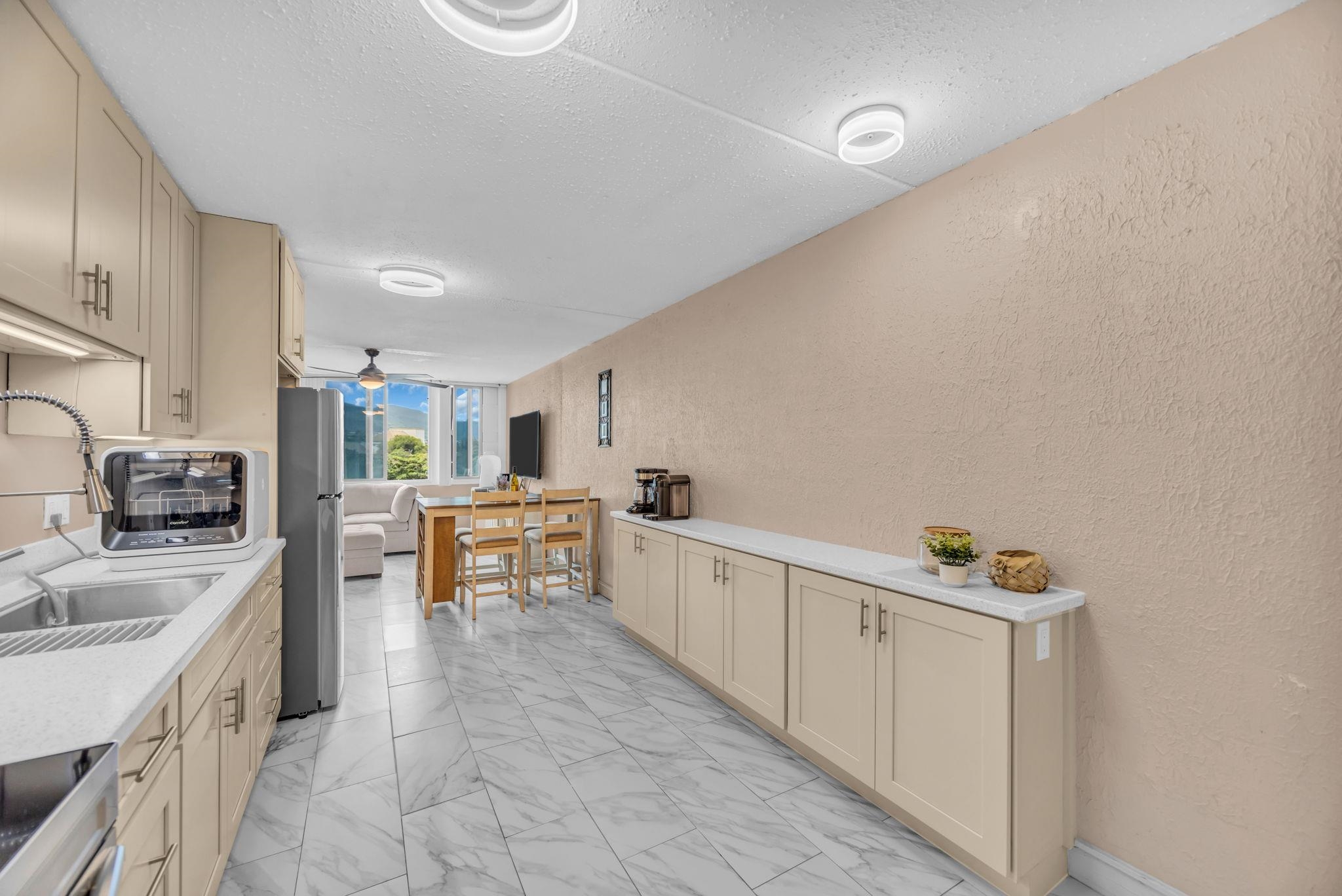 111 Kahului Beach Road, Unit D402 Kahului, HI 96732 - Photo 2 of 35 a kitchen with granite countertop a sink stove and cabinets