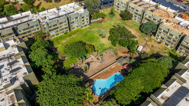 an aerial view of residential houses with outdoor space