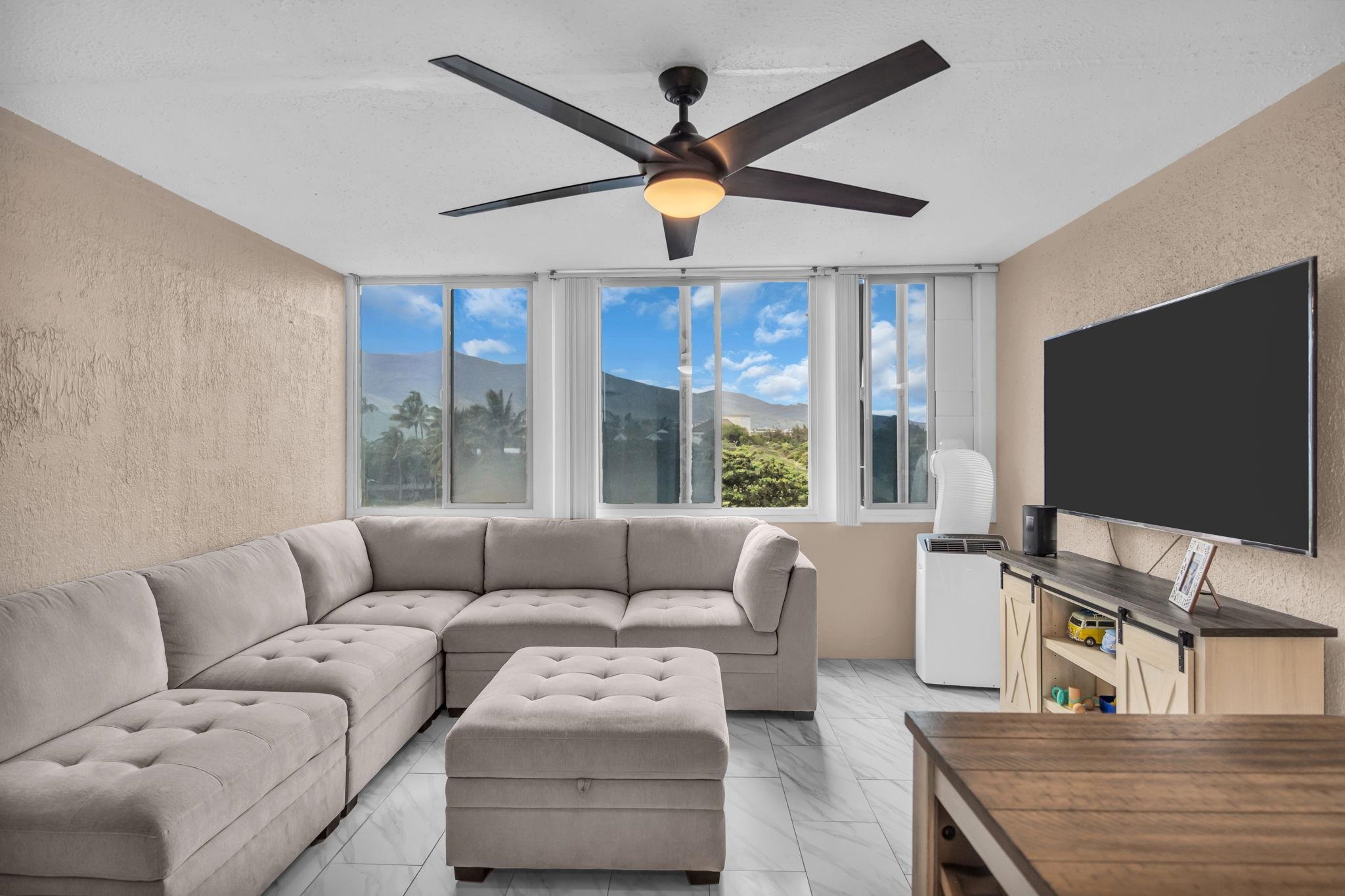 111 Kahului Beach Road, Unit D402 Kahului, HI 96732 - Photo 7 of 35 a living room with furniture and a flat screen tv