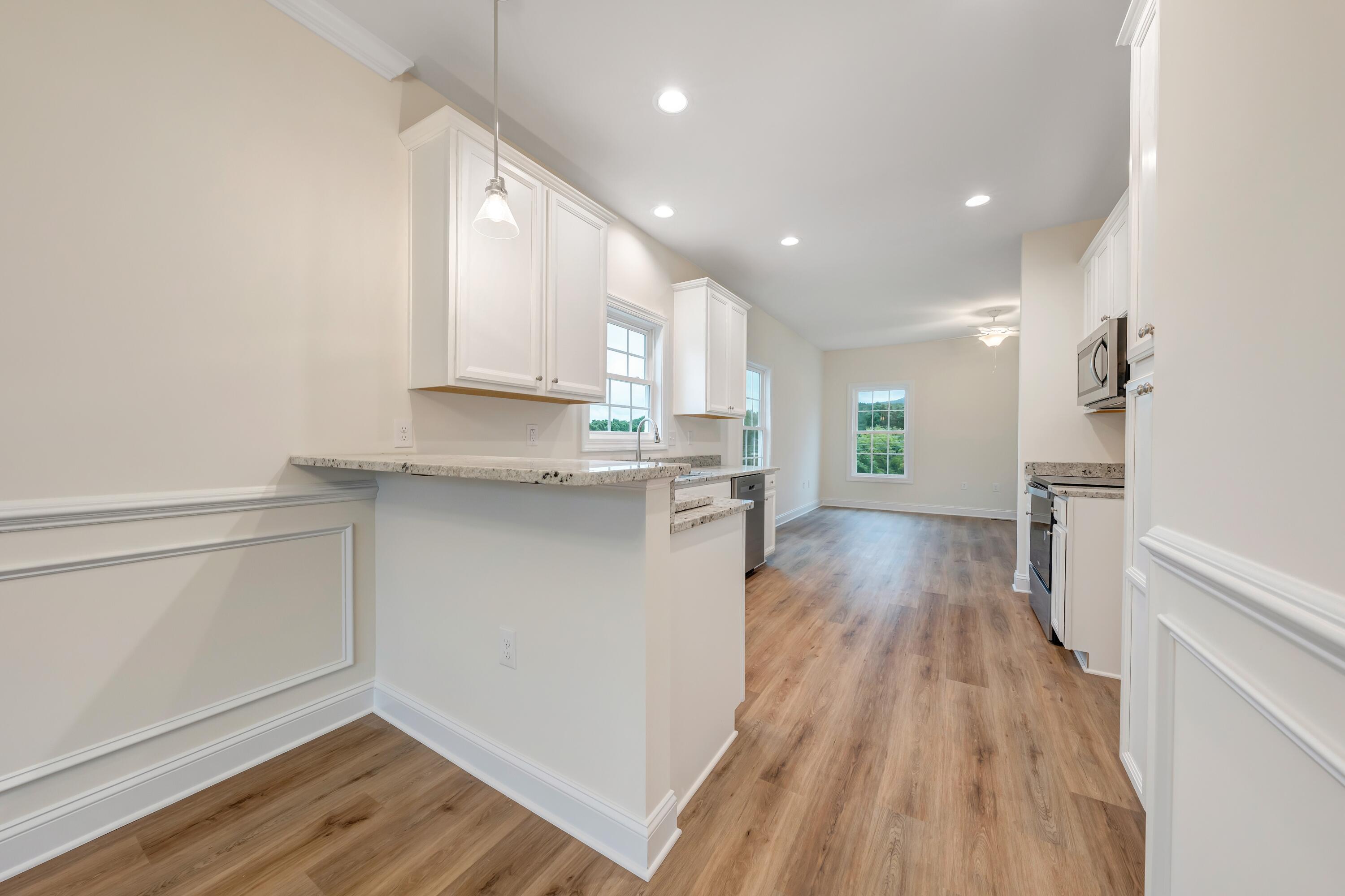 3086 Isabel Lane Salem, VA 24153 - Photo 13 of 24 a kitchen with kitchen island wooden floors appliances and cabinets