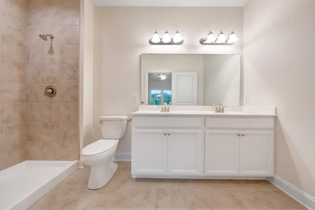 a spacious bathroom with a bathtub shower sink vanity and toilet