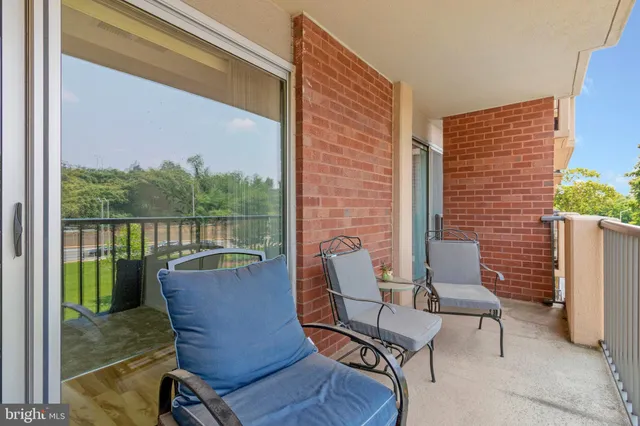 a view of two chairs in the balcony