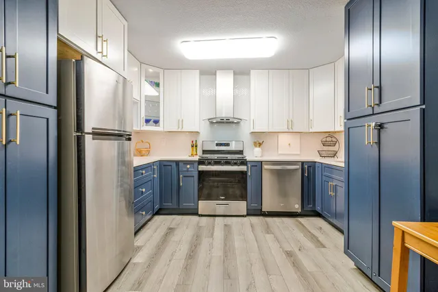 a kitchen with stainless steel appliances a refrigerator sink and cabinets