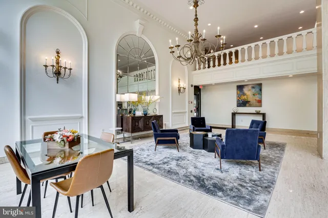 a living room with furniture and a chandelier
