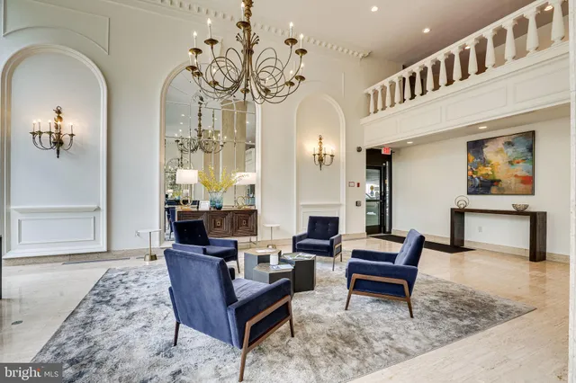 a dining room with furniture and a floor to ceiling window