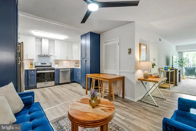 a living room with stainless steel appliances kitchen island granite countertop furniture and a dining table