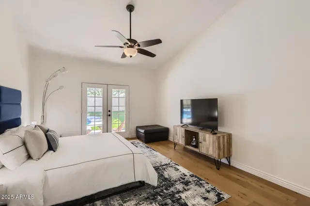 a bedroom with a bed and a flat screen tv