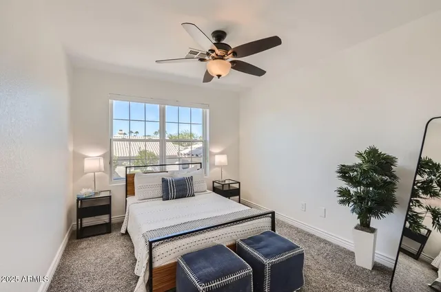 a bedroom with a bed and a potted plant