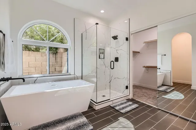 a bathroom with a tub a sink and a shower