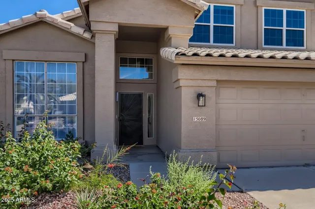 a view of a house with backyard porch and sitting area