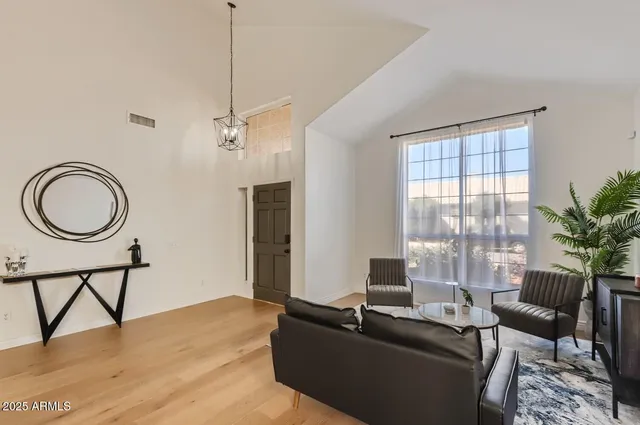 a living room with furniture a window and a wooden floor