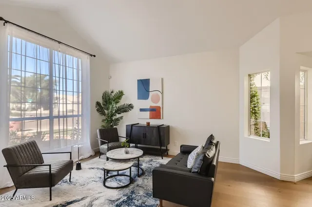 a living room with furniture and wooden floor