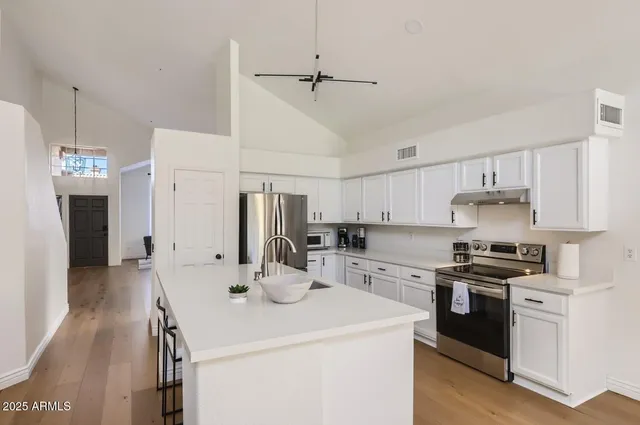 a kitchen with a sink a stove and refrigerator