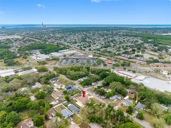 an aerial view of residential houses with outdoor space and trees