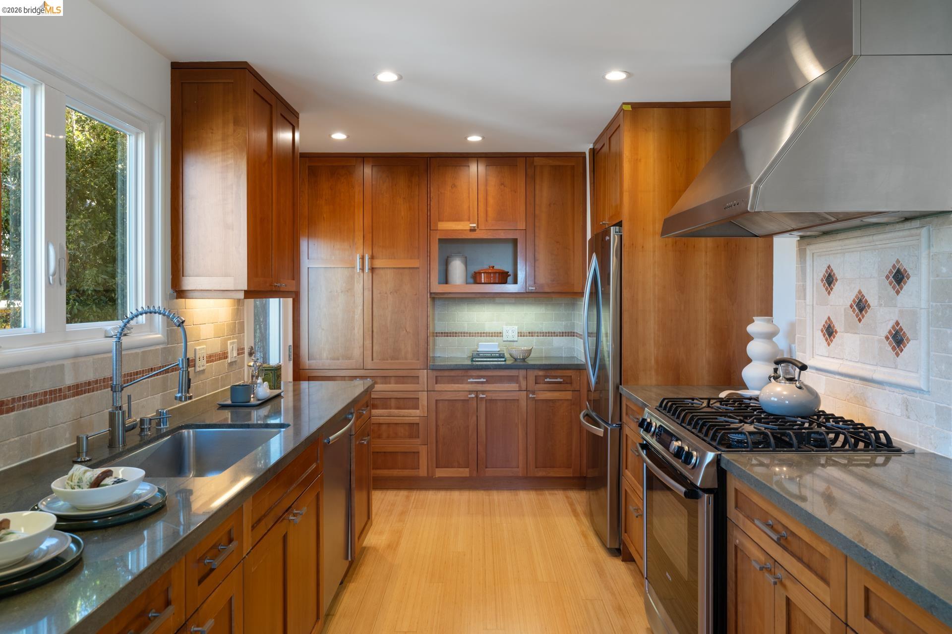 49 Windsor Avenue Kensington, CA 94708 - Photo 17 of 60 a kitchen with stainless steel appliances granite countertop sink stove and refrigerator