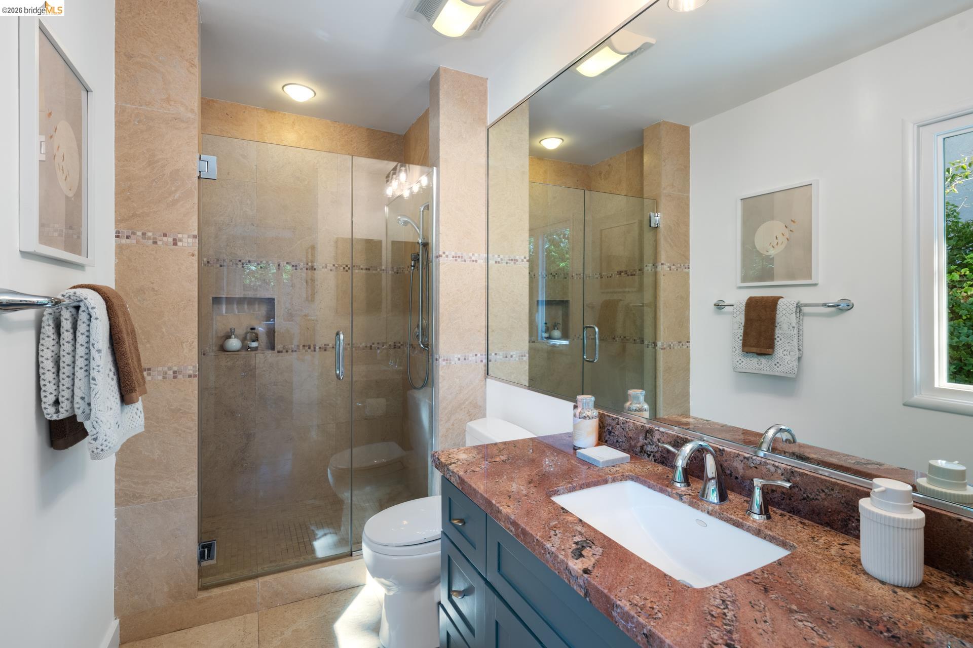 49 Windsor Avenue Kensington, CA 94708 - Photo 30 of 60 a bathroom with a granite countertop sink a toilet a shower and a mirror