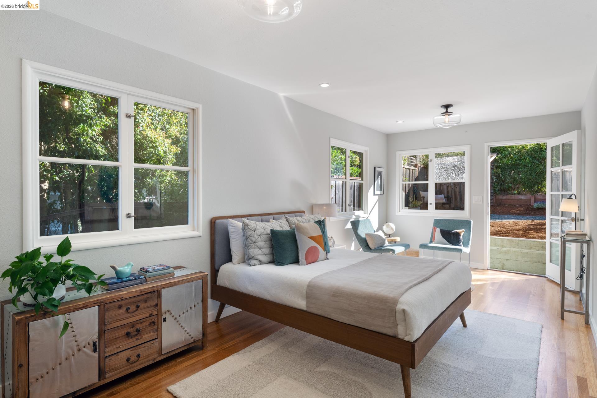 49 Windsor Avenue Kensington, CA 94708 - Photo 38 of 60 a bedroom with a large bed and large windows