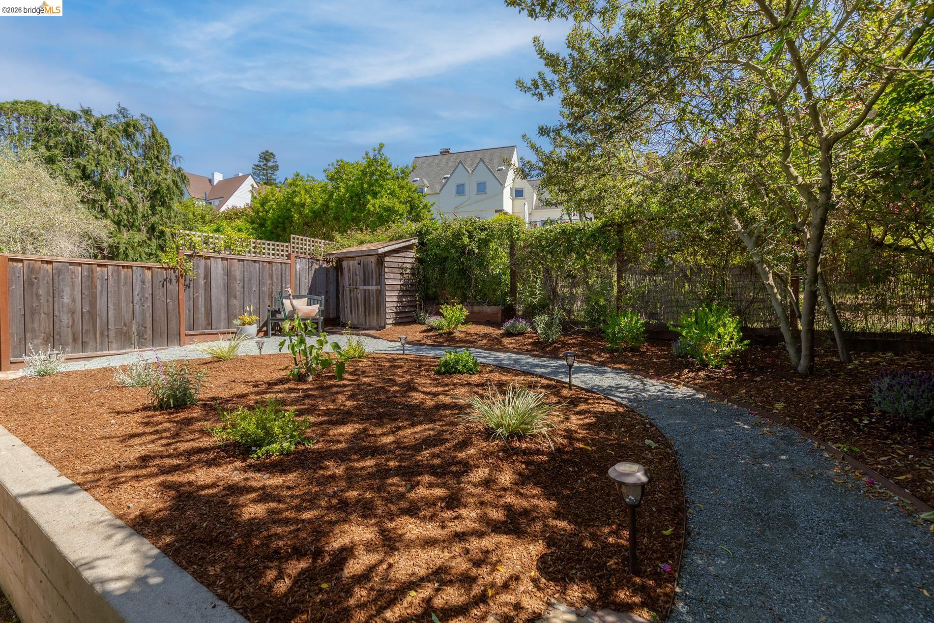 49 Windsor Avenue Kensington, CA 94708 - Photo 45 of 60 a view of a backyard with of trees and wooden fence