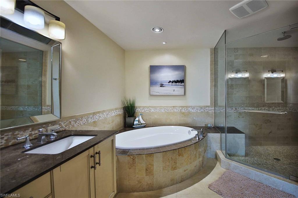 9115 Strada Place, Unit 5501 Naples, FL 34108 - Photo 21 of 32 a bathroom with a sink and a mirror