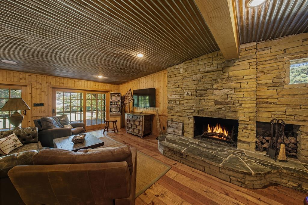 100 Letha Road Trinidad, TX 75163 - Photo 12 of 38 a living room with furniture a fireplace wooden floor and a flat screen tv