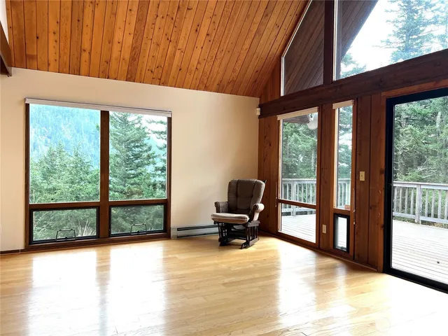 a bedroom with furniture and large windows