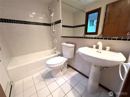 a kitchen with granite countertop cabinets sink and white appliances