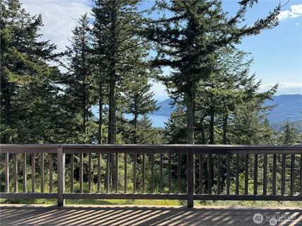 a view of balcony with wooden floor and fence