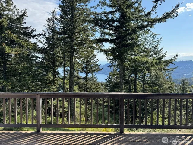 a view of balcony with wooden floor and fence