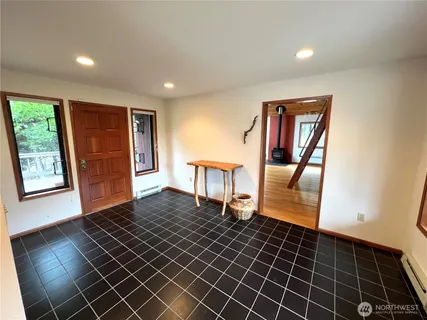 a view of hallway with wooden floor and chandelier