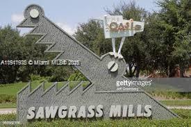 9247 Chambers Street Tamarac, FL 33321 - Photo 16 of 16 a view of a house with a yard and potted plants