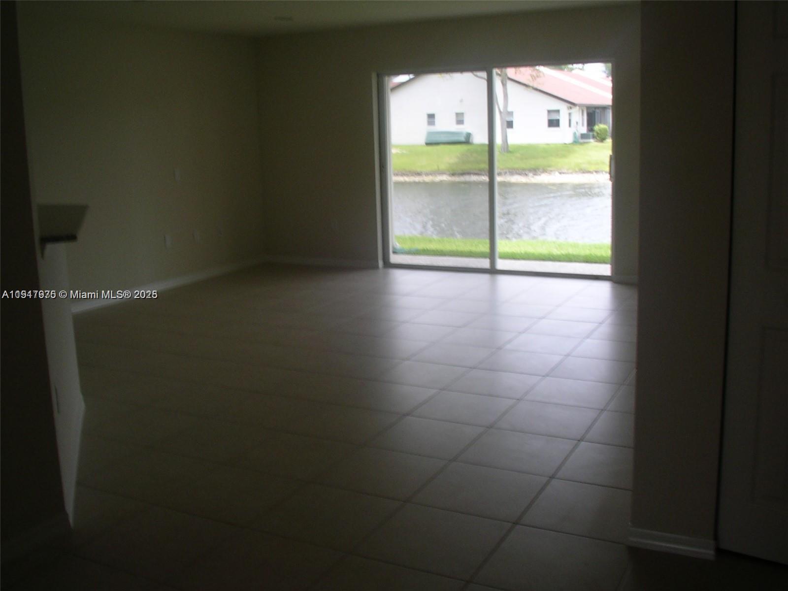 9247 Chambers Street Tamarac, FL 33321 - Photo 5 of 16 a view of an empty room with a window