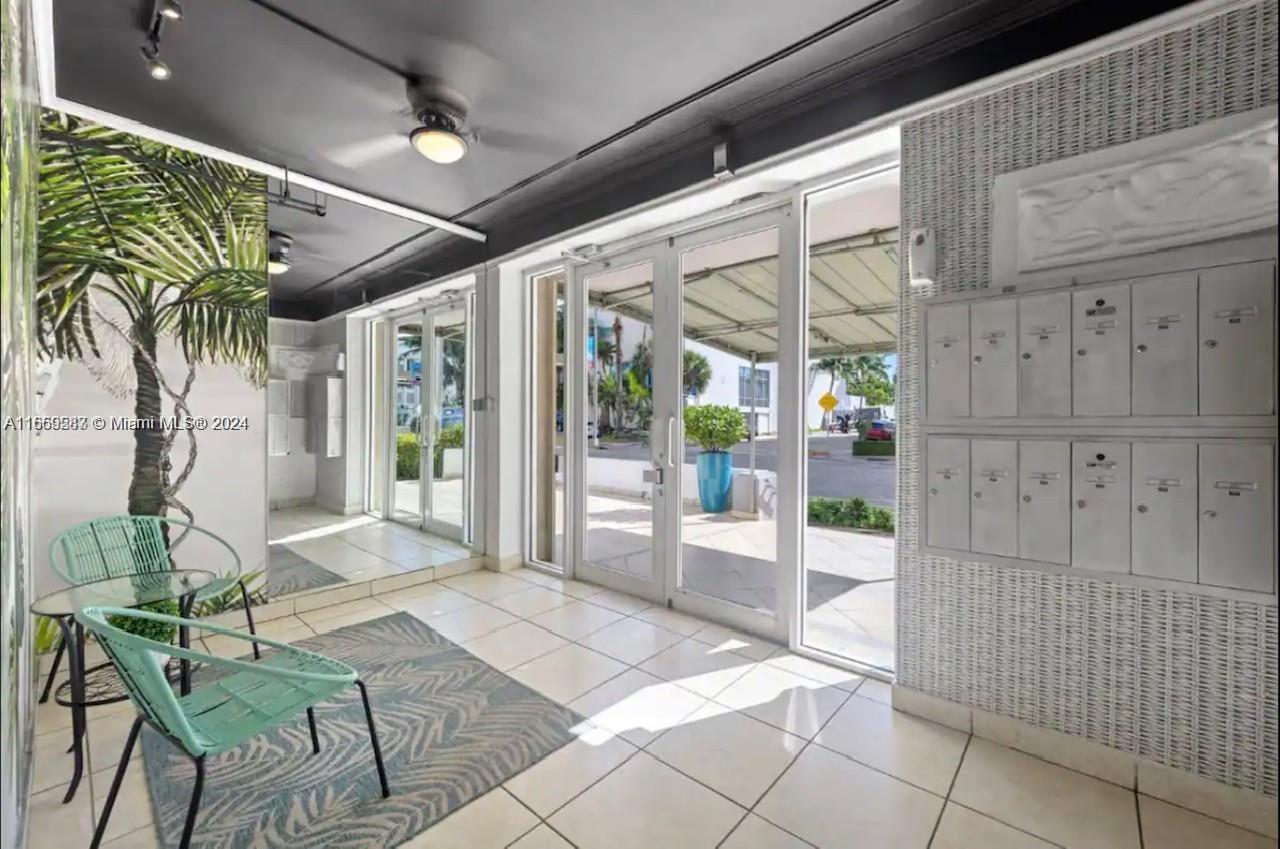 3030 Collins Avenue, Unit 3E Miami Beach, FL 33140 - Photo 12 of 20 a building outdoor space with glass windows and furniture