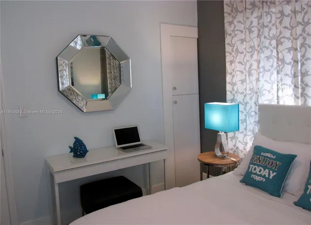 a living room with furniture and a mirror