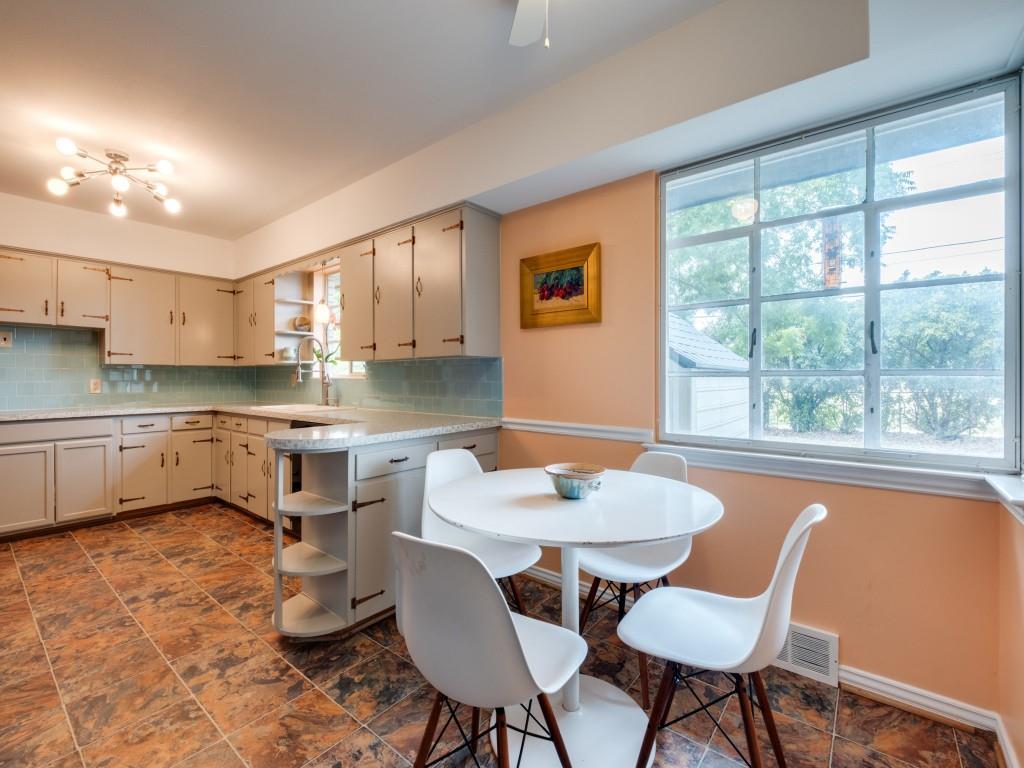 9753 Carnegie Drive Dallas, TX 75228 - Photo 11 of 25 a kitchen with a table chairs sink and cabinets
