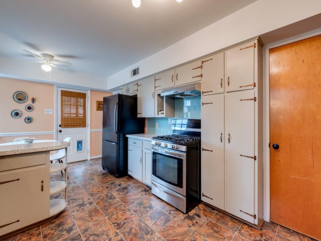 9753 Carnegie Drive Dallas, TX 75228 - Photo 13 of 25 a kitchen with stainless steel appliances granite countertop a refrigerator and a stove top oven